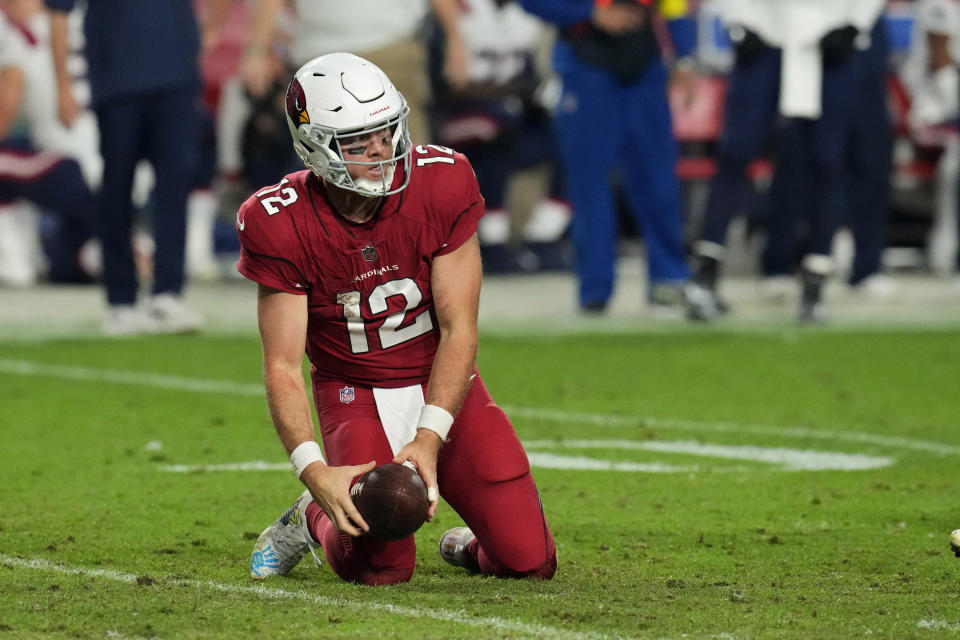 Arizona Cardinals quarterback Colt McCoy (12) kneels on the ground after he was sacked by the New England Patriots during the second half of an NFL football game, Monday, Dec. 12, 2022, in Glendale, Ariz. (AP Photo/Ross D. Franklin)