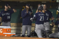 Seattle Mariners' Ty France (23) is congratulated by teammates after hitting a home run against the Oakland Athletics during the fifth inning of a baseball game in Oakland, Calif., Wednesday, Sept. 22, 2021. (AP Photo/Jeff Chiu)