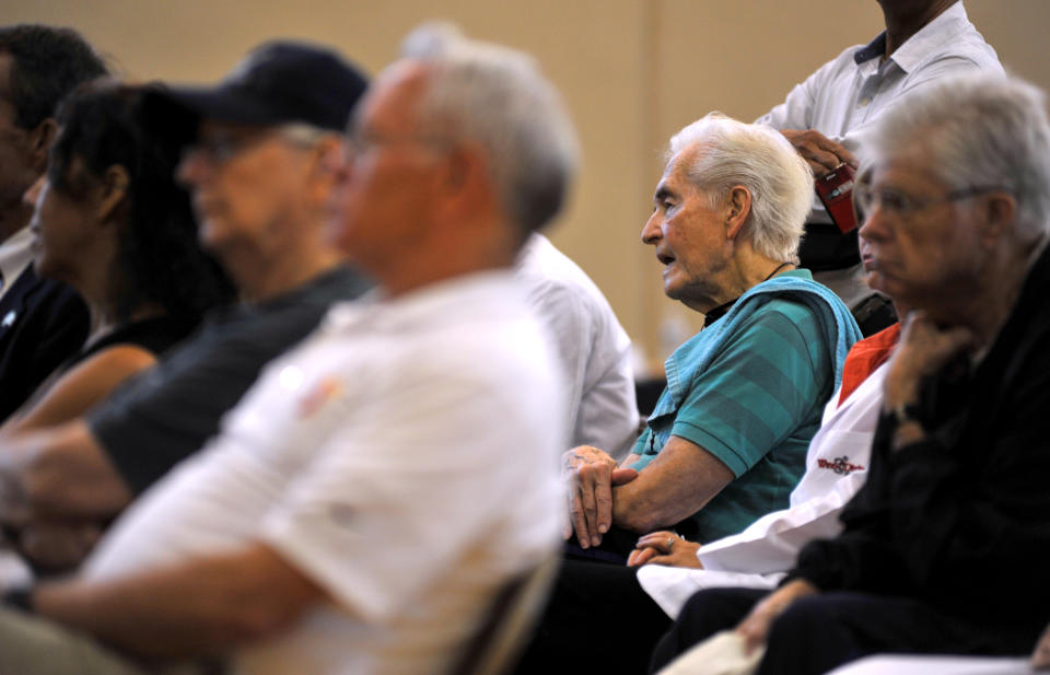 Senior citizens listen as various speakers address the group at the Williams YMCA in Jacksonville, Fla., about the seriousness of the flu. (Rick Wilson/AP Images for NCOA)