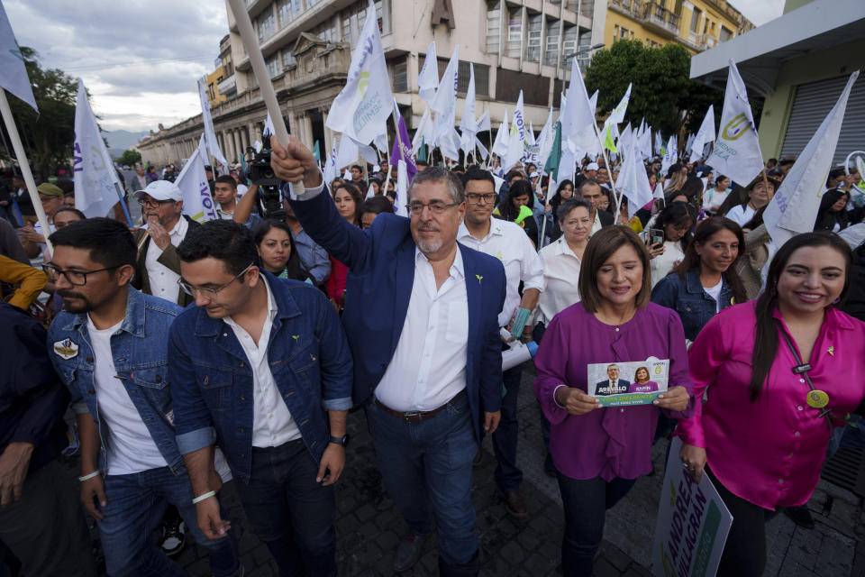 Bernardo Arevalo, presidential candidate of the Semilla party, center, walks accompanied by supporters during his closing campaign rally in Guatemala City, Wednesday, June 21, 2023. Guatemalans go to the polls on June 25. (AP Photo/Moises Castillo)