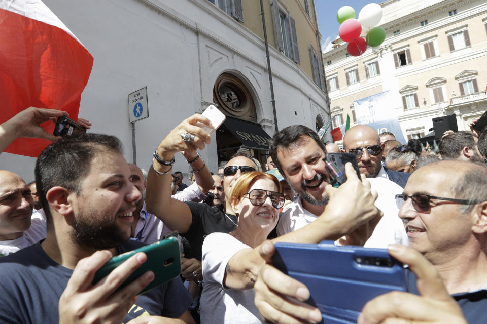 The League's leader Matteo Salvini is surrounded by supporters trying to get selfies with him during a demonstration with far-right party Brothers of Italy against the 5-Star and Democratic party coalition government, in Rome, Monday, Sept. 9, 2019. Italian Premier Giuseppe Conte is pitching for support in Parliament for his new left-leaning coalition ahead of crucial confidence votes. (AP Photo/Andrew Medichini)