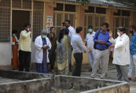 A team of experts from Indian health ministry interact with staff outside of an isolation ward for people who returned from China and under observation at the Government Fever Hospital in Hyderabad, India, Tuesday, Jan. 28, 2020. Countries with citizens in the central Chinese city that's the epicenter of a viral outbreak are planning evacuations as the number of illnesses grow and China takes drastic measures to try to stop the spread of the virus. (AP Photo/Mahesh Kumar A.)