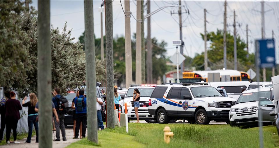 Parent  from South Fort Myers High School wait to reunite with students after a threat of a gun was called in Friday afternoon. Lee County Sheriff’s Office declared that there was no active shooter after officers searched the school.