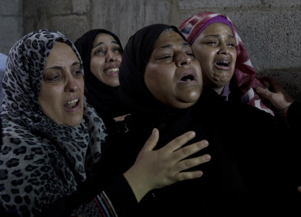 Palestinian relatives of 23 year-old Hamas fighter, Ahmad Morjan, mourn at the family home during his funeral, in the Jabaliya refugee camp, Northern Gaza Strip, Tuesday, Aug. 7, 2018. The Israeli military said it targeted a Hamas military post in northern Gaza after militants opened fire, and Hamas said two of its fighters were killed. (AP Photo/Khalil Hamra)
