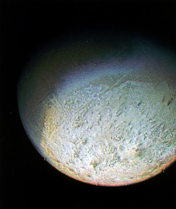 A picture shows Triton's southern hemisphere, which looks uneven.