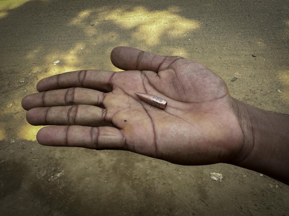 A Bangladeshi boy displays a bullet, allegedly shot from Myanmar during fighting between Myanmar security forces and Arakan Army, an ethnic minority army, in Ghumdhum, Bandarban, Bangladesh, on Monday, Feb. 5, 2024. Nearly a hundred members of Myanmar's Border Guard Police have fled their posts and taken shelter in Bangladesh during fighting between Myanmar security forces and an ethnic minority army, an official of Bangladesh's border agency said Monday. (AP Photo/Shafiqur Rahman)