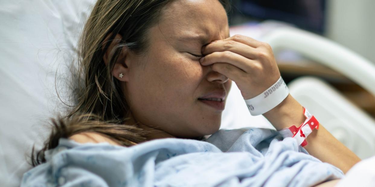 sad woman in hospital bed stillbirth