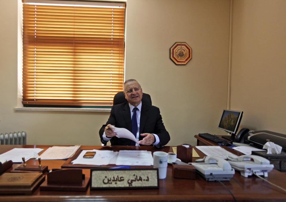 In this Wednesday, April 9, 2014 photo, Palestinian Hani Abdeen, Dean of the Faculty of Medicine, reviews papers in his office at the Al-Quds University in the West Bank village of Abu Dis, near Jerusalem. Dozens of Palestinian doctors who graduated from Al-Quds University, a school that has a foothold in east Jerusalem, are caught in the political battle between Israel and the Palestinians over the city’s eastern sector. Israel has refused to recognize the university’s graduates -- a move that could amount to acknowledging the Palestinian claims to east Jerusalem as their capital. (AP Photo/Majdi Mohammed)