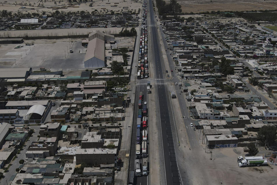 Truckers are backed up on the Pan-American highway because supporters of ousted Peruvian President Pedro Castillo are blocking it in protest of his detention, in Ica, Peru, Tuesday, Dec. 13, 2022. Castillo said Tuesday he is being "unjustly and arbitrarily detained" and thanked his supporters for their "effort and fight" since he was taken into custody last week. (AP Photo/Martin Mejia)