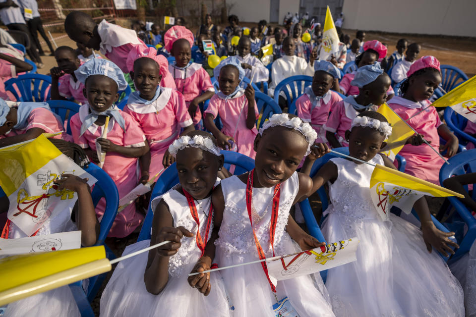 Young girls await the arrival of Pope Francis at the St. Theresa Cathedral in Juba, South Sudan, Saturday, Feb. 4, 2023. Pope Francis is in South Sudan on the second leg of a six-day trip that started in Congo, hoping to bring comfort and encouragement to two countries that have been riven by poverty, conflicts and what he calls a "colonialist mentality" that has exploited Africa for centuries. (AP Photo/Ben Curtis)