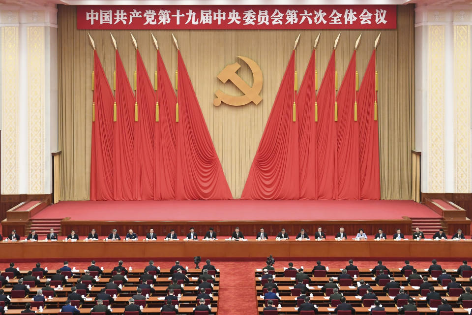 In this photo released on Nov. 11, 2021, by Xinhua News Agency, members of the Standing Committee of the Political Bureau of the Communist Party of China (CPC) Central Committee, including Chinese President Xi Jinping attend the sixth plenary session of the 19th Central Committee of the Communist Party of China (CPC) in Beijing. Words on the banner reads "The 19th Communist Party of China Central Committee sixth plenary session" (Zhai Jianlan/Xinhua via AP)