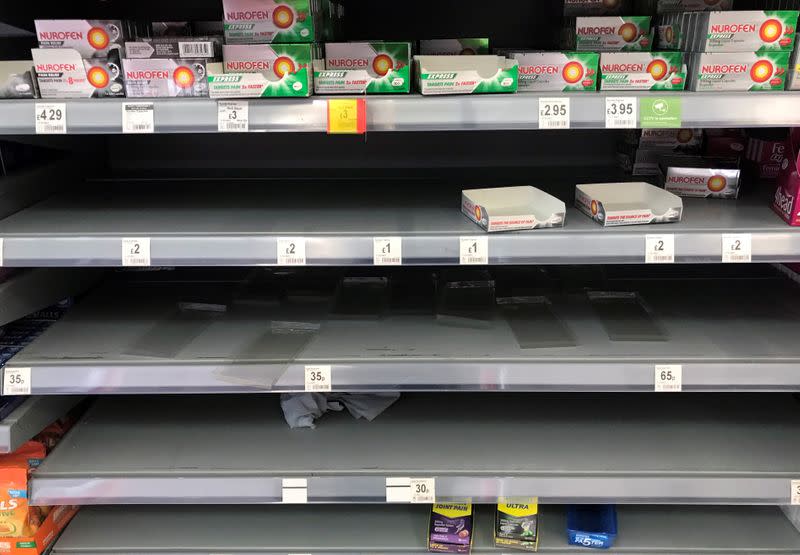 Empty shelves are seen on the over the counter medicines aisle inside an Asda supermarket in Milton Keynes