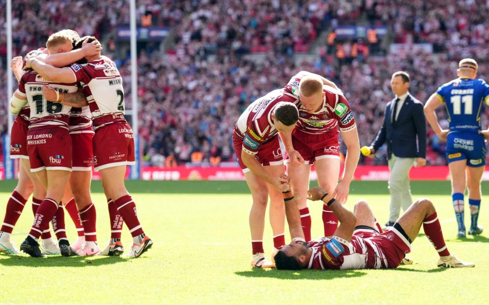 Wigan Warriors' Bevan French (on the ground) celebrates with team-mates after victory in the Challenge Cup final