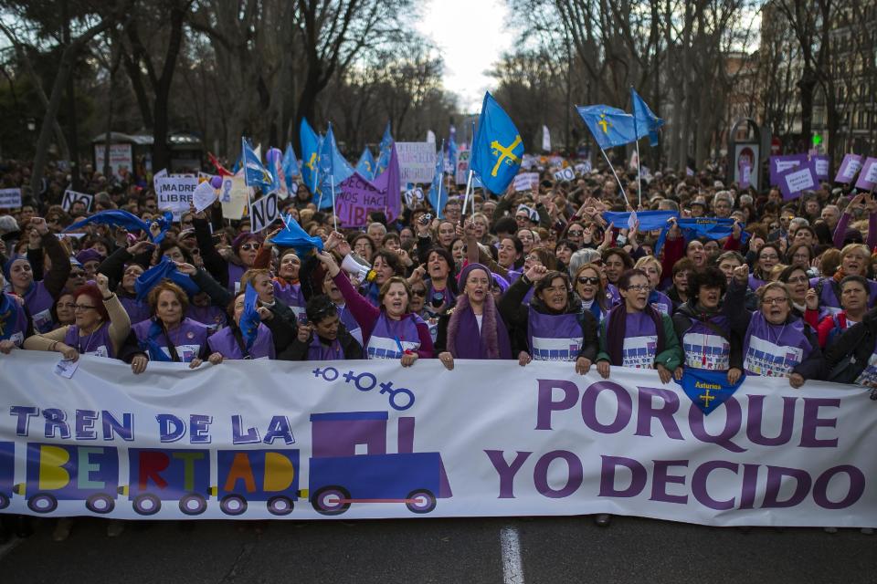 Protestors shout slogans as they march to the Spanish Parliament during a protest against government's plan to implement major restrictions on abortion in Madrid, Spain, Saturday, Feb. 1, 2014. The rally was organized Saturday by dozens of women's groups that fight for reproductive rights. Banner reads "…Because I decide. Train of Freedom". (AP Photo/Andres Kudacki)