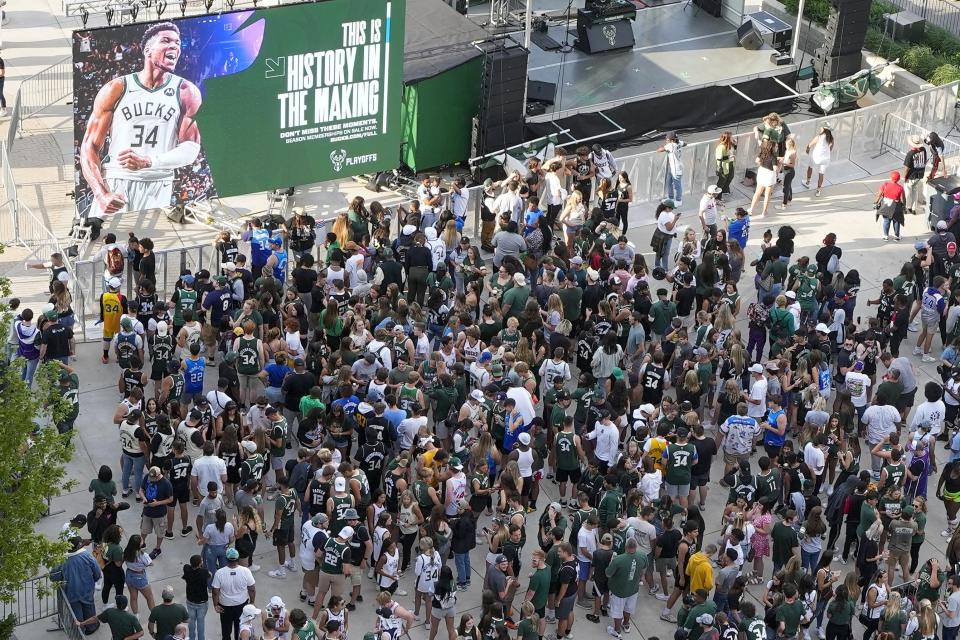 Fans gather outside the Fiserv Forum to watch Game 1 of the NBA Eastern Conference basketball finals game between the Milwaukee Bucks and the Atlanta Hawks Wednesday, June 23, 2021, in Milwaukee. (AP Photo/Morry Gash)