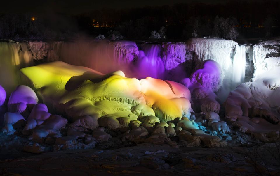 A partially frozen Niagara Falls is seen on the American side lit by lights during sub freezing temperatures in Niagara Falls