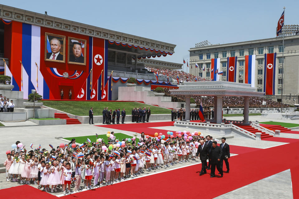 Russian President Vladimir Putin, left, and North Korea's leader Kim Jong Un, foreground right, attend the official welcome ceremony in the Kim Il Sung Square in Pyongyang, North Korea, on Wednesday, June 19, 2024. (Vladimir Smirnov, Sputnik, KremlinPhoto via AP)