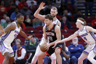 Houston Rockets center Alperen Sengun (28) looks for a way to the basket between Sacramento Kings forwards Harrison Barnes (40) Domantas Sabonis, back, as guard Kevin Huerter (9) reaches in during the first half of an NBA basketball game Monday, Feb. 6, 2023, in Houston. (AP Photo/Michael Wyke)