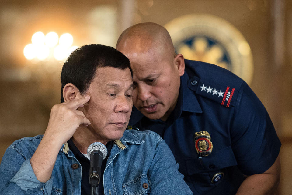 <p>Philippine National Police Director General Ronald Dela Rosa speaks into the ear of Philippine President Rodrigo Duterte during a press conference at the Malacanang palace in Manila, Philippines, Jan. 30, 2017. (Noel Celis/AFP/Getty Images) </p>