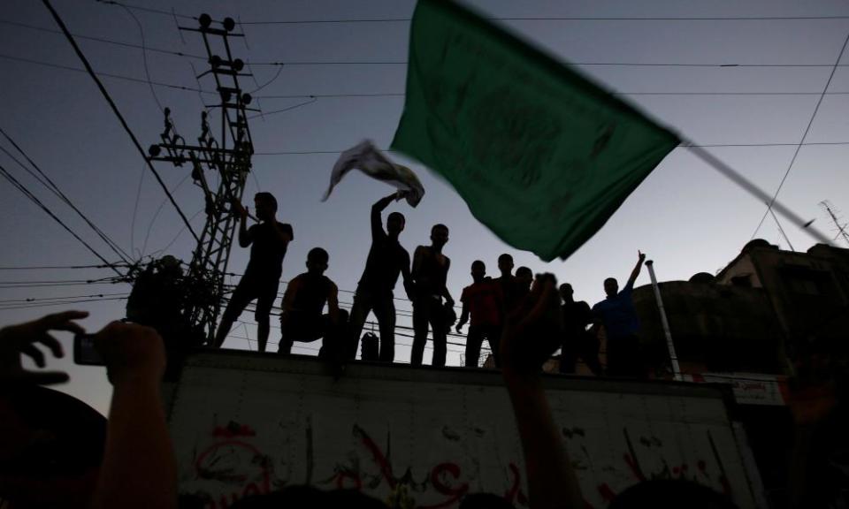 A Palestinian person waves a Hamas flag in Gaza City. The group’s new charter could be the last chance ‘to put Gaza on a sensible path’, says a diplomatic source.
