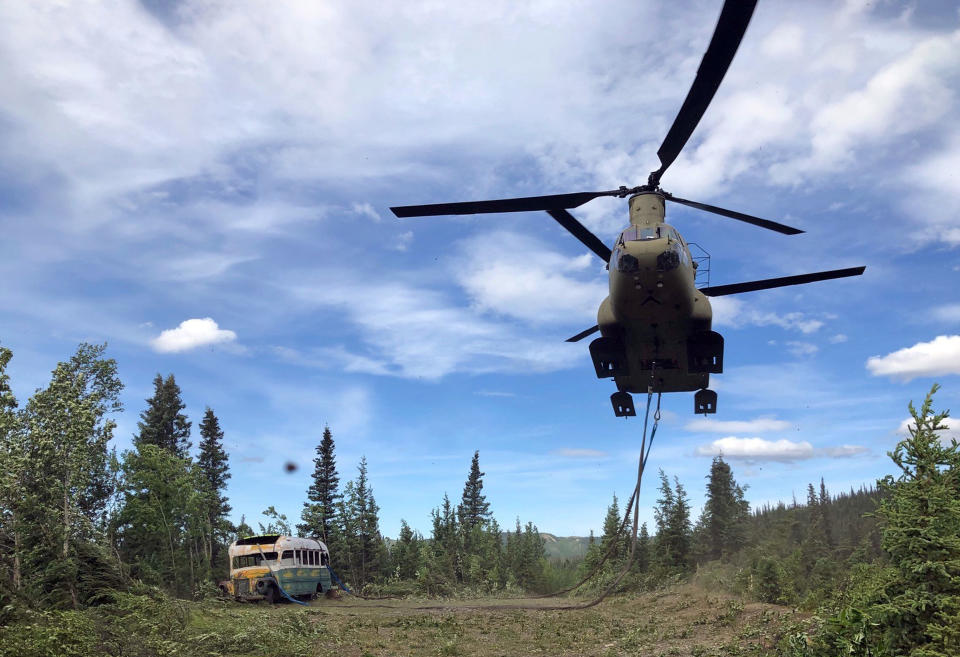 In this photo released by the Alaska National Guard, Alaska Army National Guard soldiers use a CH-47 Chinook helicopter to removed an abandoned bus, popularized by the book and movie "Into the Wild," out of its location in the Alaska backcountry Thursday, June 18, 2020, as part of a training mission. Alaska Natural Resources Commissioner Corri Feige, in a release, said the bus will be kept in a secure location while her department weighs various options for what to do with it. (Sgt. Seth LaCount/Alaska National Guard via AP)