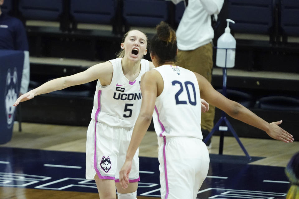 Connecticut guard Paige Bueckers (5) reacts after her three-point basket against South Carolina in overtime of an NCAA college basketball game in Storrs, Conn., Monday, Feb. 8, 2021. (David Butler/Pool Photo via AP)