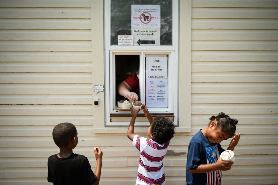 Jalen, left to right, Gabriel and Isaiah Robinson get their order of ice cream at Gillis Hill Farm on Monday, July 6, 2020.