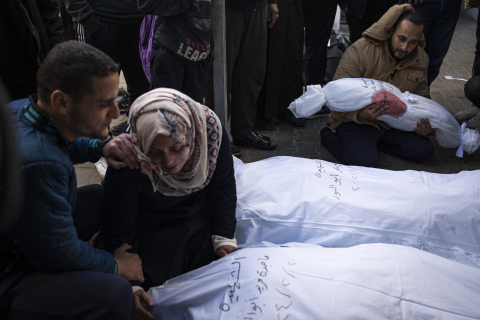 Palestinians mourn relatives killed in the Israeli bombardment of the Gaza Strip at a hospital morgue in Rafah, Wednesday, Feb. 21, 2024. (AP Photo/Fatima Shbair)