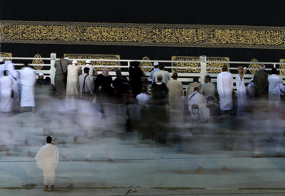 <p>This long exposure photograph shows Muslim pilgrims circumambulating the Kaaba, Islam’s holiest shrine, at the Grand Mosque in Saudi Arabia’s holy city of Mecca, on Aug. 29, 2017, on the eve of the start of the annual hajj pilgrimage. (Photo: Karim Sahib/AFP/Getty Images) </p>