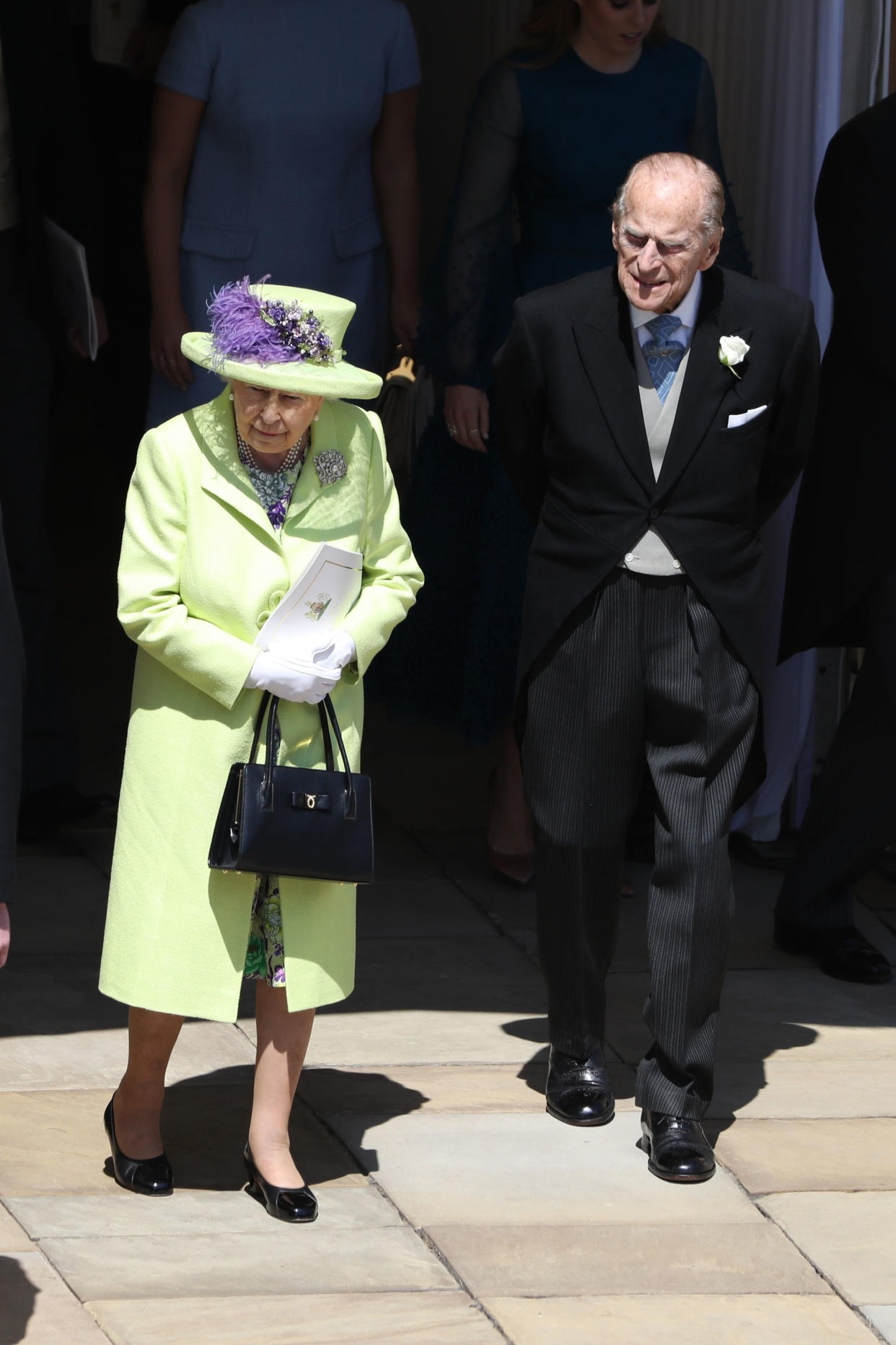 Britain's Queen Elizabeth II and Britain's Prince Philip, Duke of Edinburgh come out to watch Britain's Prince Harry, Duke of Sussex and his wife Meghan, Duchess of Sussex begin their carriage procession in the Ascot Landau Carriage after their wedding ceremony at St George's Chapel, Windsor Castle, in Windsor, on May 19, 2018. (Photo by ANDREW MILLIGAN / POOL / AFP) (Photo by ANDREW MILLIGAN/POOL/AFP via Getty Images)