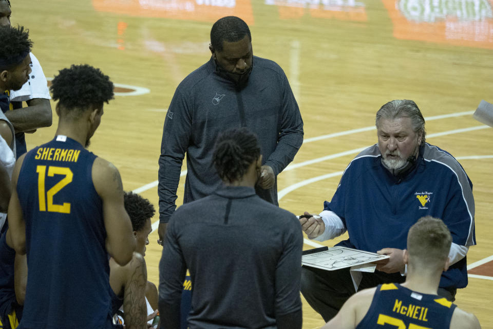 West Virginia head coach Bob Huggins draws a play for his team during the second half of an NCAA college basketball game against Texas, Saturday, Feb. 20, 2021, in Austin, Texas. (AP Photo/Michael Thomas)