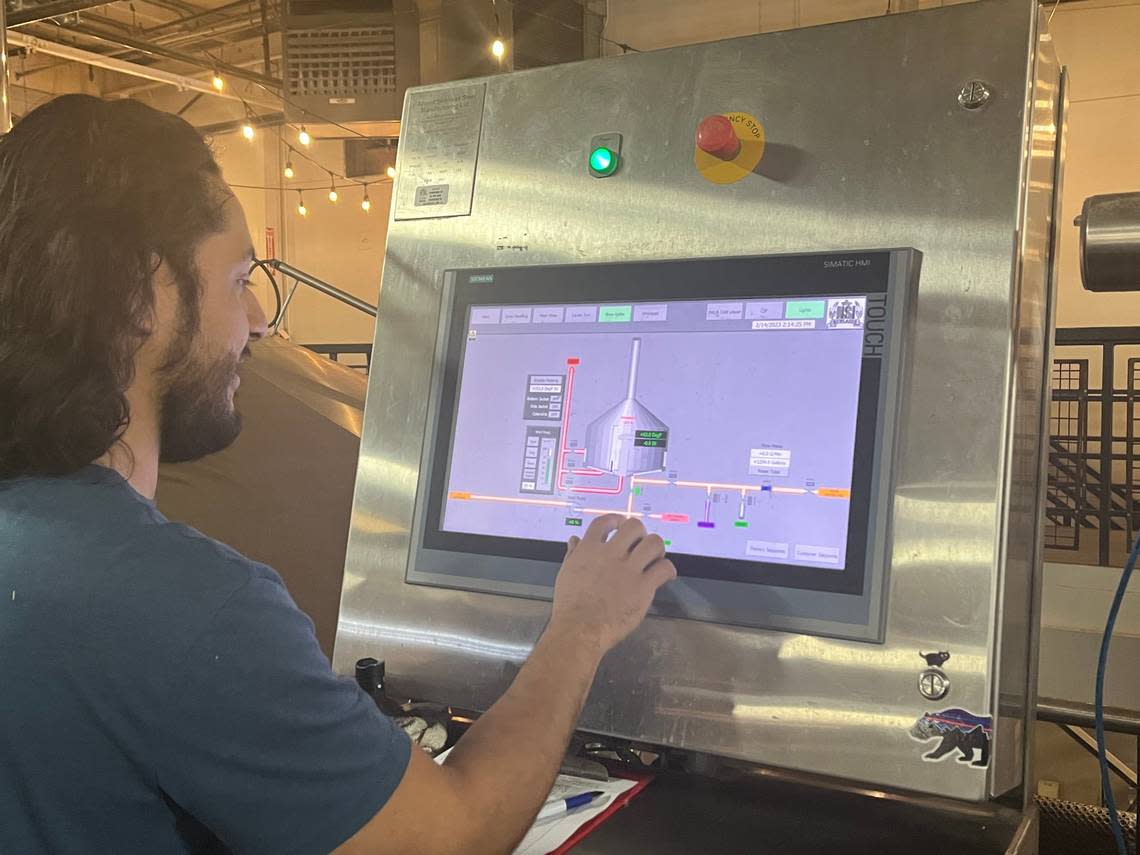 Payette Brewing lead brewer David Torres demonstrates that the brew system is all controlled by a touch screen.