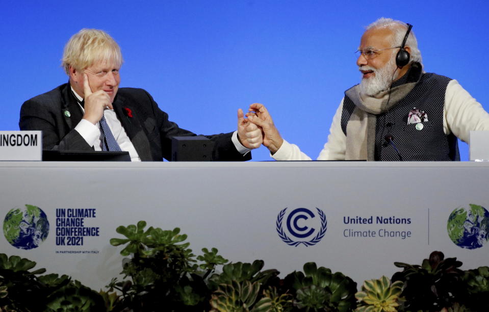 FILE - Britain's Prime Minister Boris Johnson and India's Prime Minister Narendra Modi, right, attend a meeting during the UN Climate Change Conference COP26 in Glasgow, Scotland, Tuesday, Nov. 2, 2021. The moving vans have already started arriving in Downing Street, as Britain's Conservative Party prepares to evict Johnson. Debate about what mark he will leave on his party, his country and the world will linger long after he departs in September. (Phil Noble/Pool via AP, File)