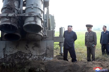 North Korean leader Kim Jong Un attends the testing of a super-large multiple rocket launcher in North Korea