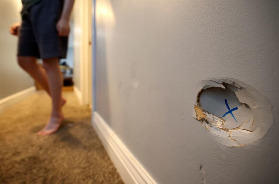 Holes of various sizes are found all over the walls in Connor Campbell’s home in Provo on Sunday, May 28, 2023. The hole pictured is at the bottom of a staircase and happened when Campbell had a seizure, fell down the stairs, and his head hit the wall. Campbell, 16, is autistic, nonverbal and has epilepsy. He lives at the Utah State Developmental Center in American Fork but comes home on Sundays. | Kristin Murphy, Deseret News