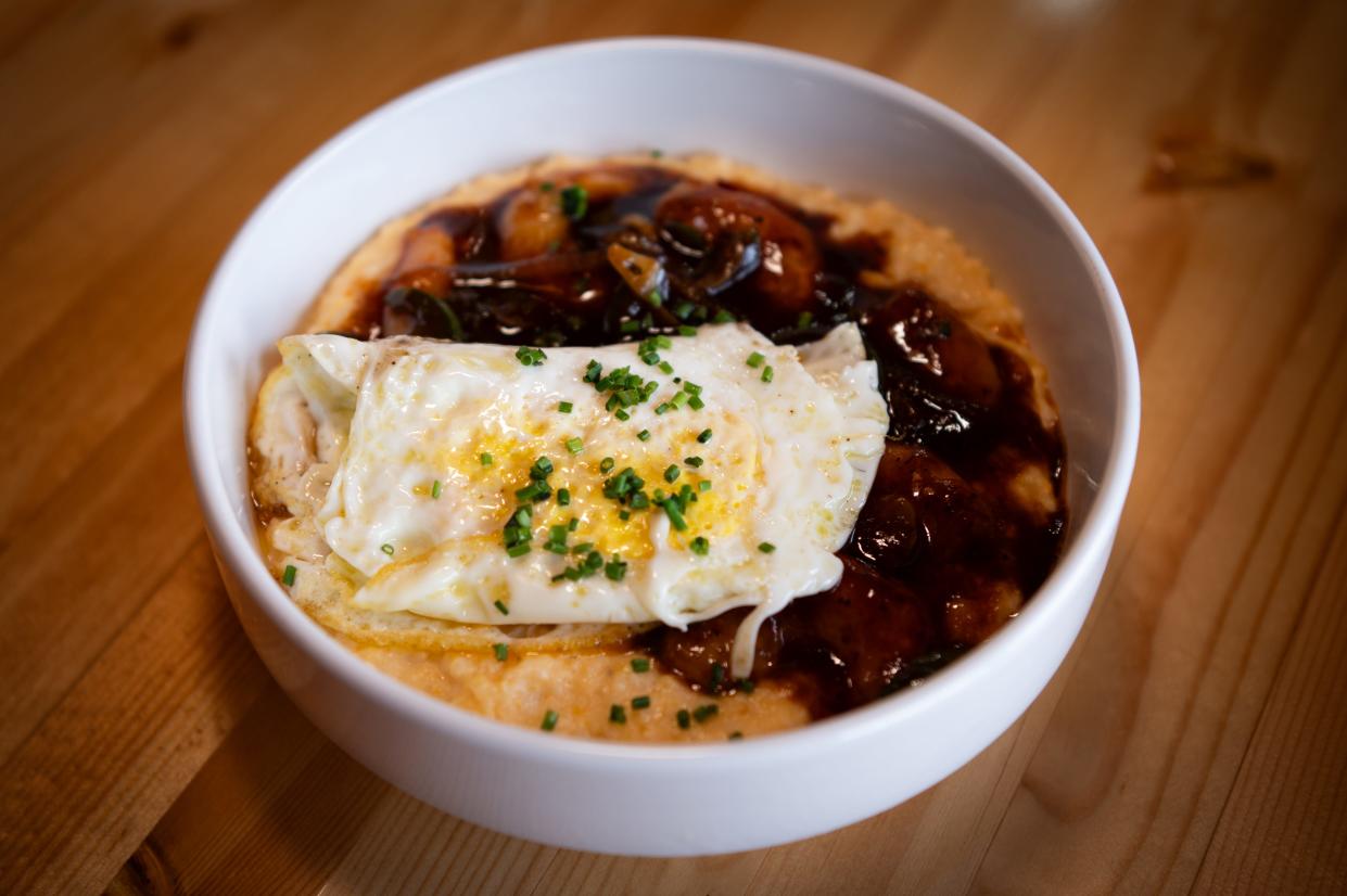 Regina's Westside's shrimp and grits consist of shallot, jalapenos, root beer barbecue sauce and cheddar grits and served with two over medium eggs.