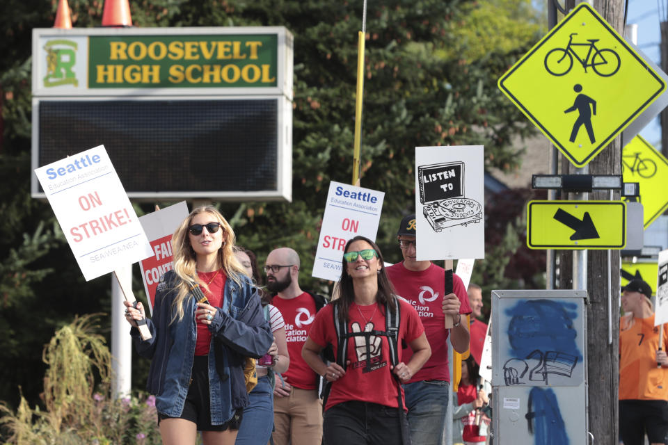 Teachers from Seattle Public Schools picket outside Roosevelt High School on what was supposed to be the first day of classes, Wednesday, Sept. 7, 2022, in Seattle. The first day of classes at Seattle Public Schools was cancelled and teachers are on strike over issues that include pay, mental health support, and staffing ratios for special education and multilingual students. (AP Photo/Jason Redmond)