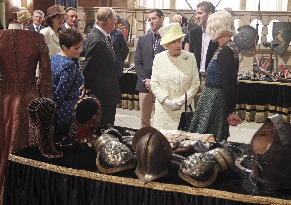 Britain's Queen Elizabeth looks at props as she visits the set of TV series Game of Thrones, in Belfast