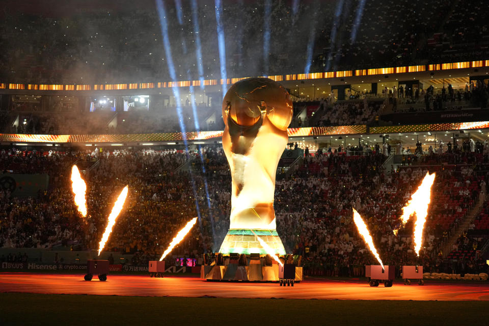 AL KHOR, QATAR - NOVEMBER 20: FIFA World Cup trophy replica displayed as fireworks set off on the pitch during the official opening ceremony of FIFA World Cup Qatar 2022 ahead of the opening match between Qatar and Ecuador at Al Bayt Stadium in Al Khor City, Qatar on November 20, 2022. (Photo by Salih Zeki Fazlioglu/Anadolu Agency via Getty Images)