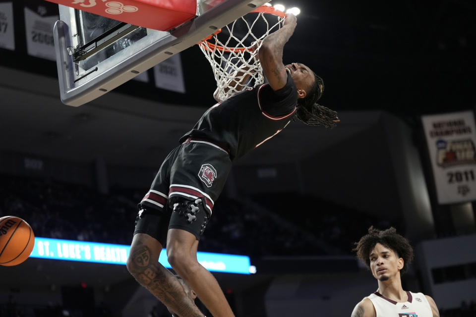 South Carolina guard Zachary Davis dunks next to Texas A&M forward Andersson Garcia during the second half of an NCAA college basketball game Wednesday, Feb. 28, 2024, in College Station, Texas. (AP Photo/Sam Craft)