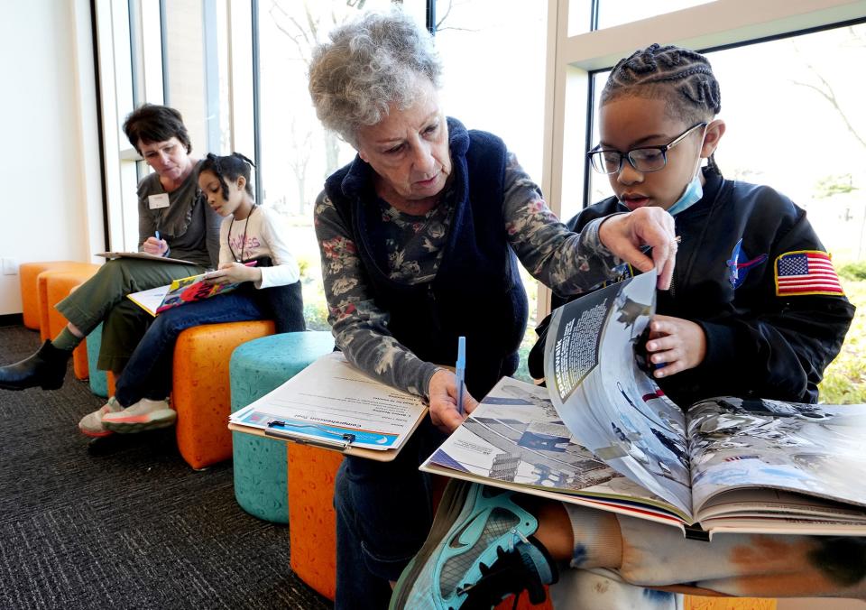 The Columbus Metropolitan Library has a Reading Buddies program which connects K-3 students with an adult buddy for one-on-one reading. Shirlee Doron, of Columbus, second from right, works with Justin Wooden, 8, of Westerville, far right, at the Karl Rd. branch of the Columbus Metropolitan Library on Thursday, April 14, 2022. In the background, Andrea Danner of Columbus works with Brooklyn Staten, 8, of Columbus.