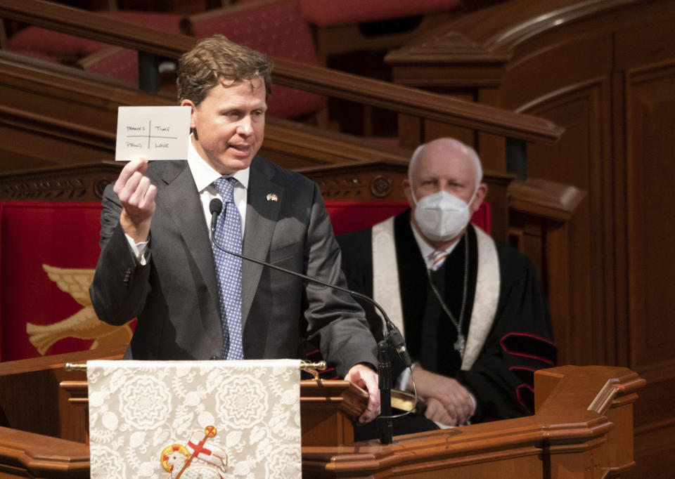 Kevin Isakson holds up his notecard while speaking about his late father former Sen. Johnny Isakson during a funeral service at Peachtree Road United Methodist Church, Thursday afternoon, Jan. 6, 2022, in Atlanta. Isakson, 76, died Dec. 19, 2021, at his home in Atlanta. (Ben Gray/Atlanta Journal-Constitution via AP)