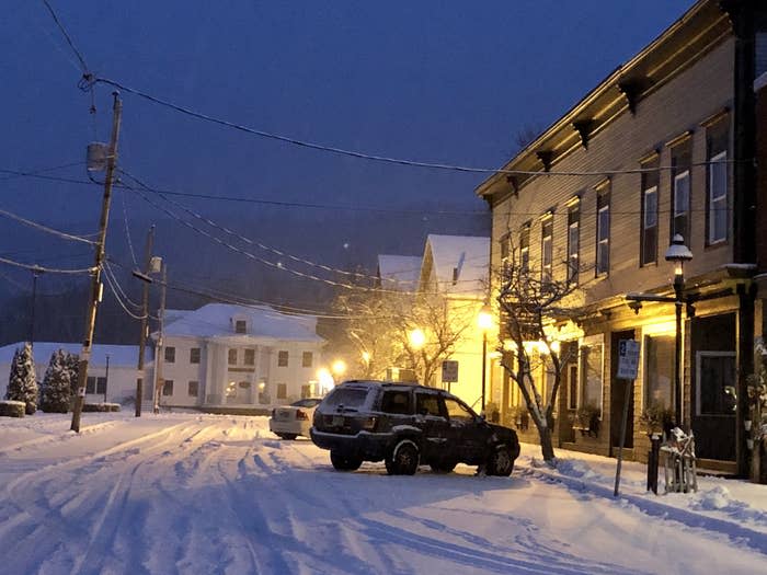 A car parked on a snowy, desolate street