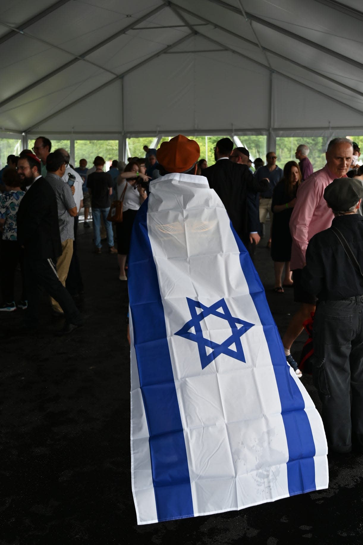 Ray Warren, of Amberley Village, walks through a gathering against antisemitism on Sunday, June 13, 2021 outside of the Jewish Federation of Cincinnati. The gathering was organized by the Jewish Federation of Cincinnati, the Jewish Community Relations Council, Mayerson JCC of Cincinnati, Holocaust & Humanity Center, Ish, and the Greater Cincinnati Board of Rabbis because of a recent rise in antisemitic hate crimes.