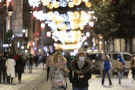 People, wearing masks to help curb the spread of the coronavirus, walk in Istiklal street, the main shopping street in Istanbul, late Wednesday, Nov. 25, 2020. The number of daily COVID-19 infections in Turkey jumped to above 28,000 on Wednesday after, in a surprise development, the government resumed publishing all positive cases and not just the number of patients being treated for symptoms of the coronavirus.The government was accused of hiding the full extent of the virus spread in Turkey, after it was revealed that the number of asymptomatic cases were not being included in data published since July 29. (AP Photo)