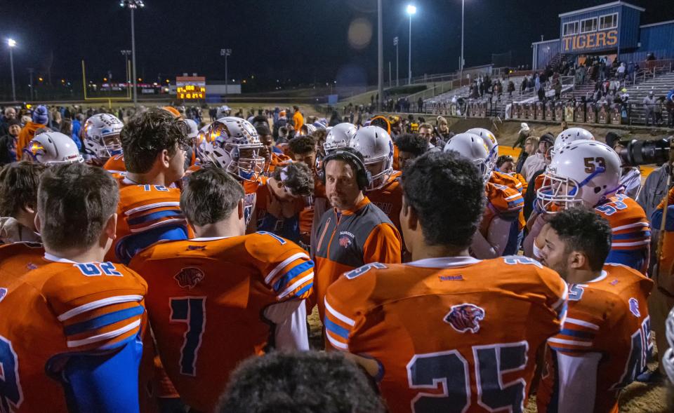 Randleman Tigers head coach Shane Handy talks with his team after their loss to Salisbury, in what will be Handy&#8217;s final game as head coach of the Randleman Tigers. Handy is leaving after 12 years at RHS to take over the head coaching position at Clayton High School.
