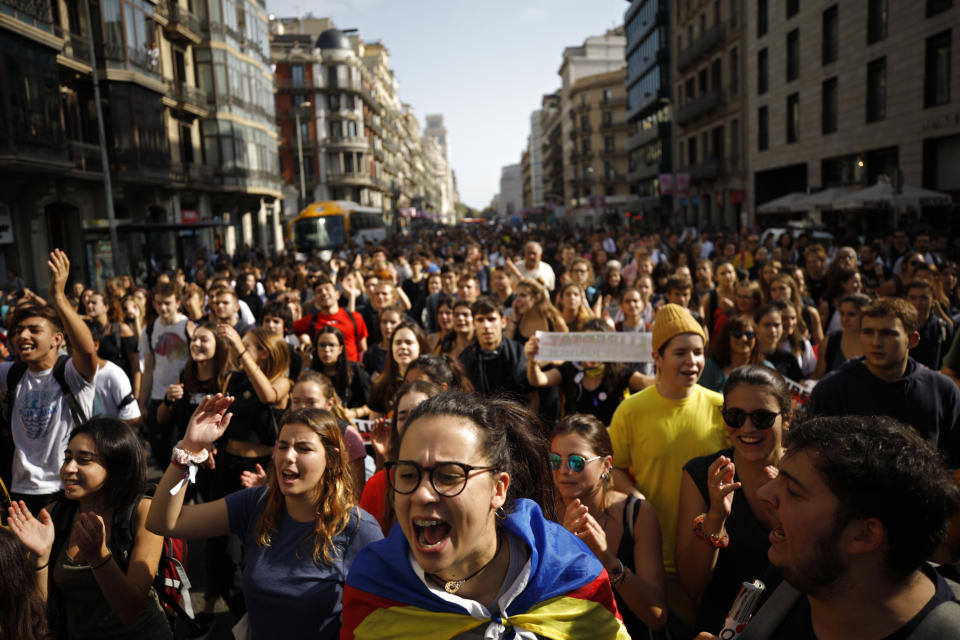 Protestors crowd a street in Barcelona, Spain, Monday, Oct. 14, 2019. Spain's Supreme Court on Monday convicted 12 former Catalan politicians and activists for their roles in a secession bid in 2017, a ruling that immediately inflamed independence supporters in the wealthy northeastern region. (AP Photo/Emilio Morenatti)