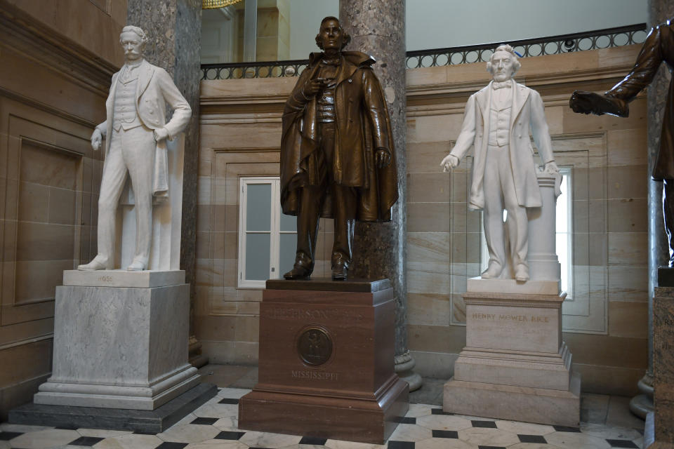 FILE - In this June 11, 2020, file photo a statue of Jefferson Davis of Mississippi is on display in Statuary Hall on Capitol Hill in Washington. The House is expected to approve a bill Tuesday that would remove from the Capitol a bust of Roger Taney, the U.S. chief justice best known for an infamous pro-slavery decision, as well as statues of Jefferson Davis and others who served in the Confederacy. (AP Photo/Susan Walsh, File)