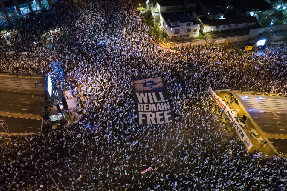 FILE - Tens of thousands of Israelis protest against plans by Prime Minister Benjamin Netanyahu's government to overhaul the judicial system in Tel Aviv, Israel, Saturday, April 15, 2023. As Israel turns 75, it has much to celebrate. But instead of feting its accomplishments as a regional and economic powerhouse, the nation founded as a home for the world's Jews in the wake of the Holocaust finds itself under threat -- not by foreign enemies but by bitter internal divisions. (AP Photo/Oded Balilty, File)