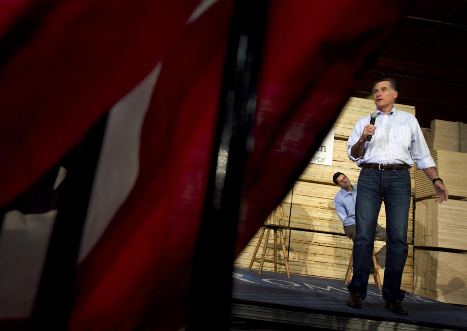 Republican presidential candidate, former Massachusetts Gov. Mitt Romney, accompanied by House Budget Committee Chairman Rep. Paul Ryan, R-Wis., speaks at a building supply store in Green Bay, Wis., Monday, April 2, 2012. (AP Photo/Steven Senne)